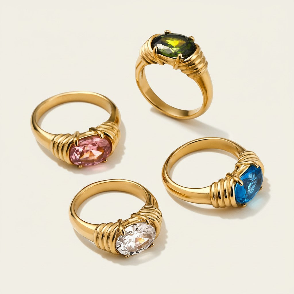 Seraphina Treasures Meliora rings with oval-cut pink, green, blue, and clear stones set in gold-tone metal.
