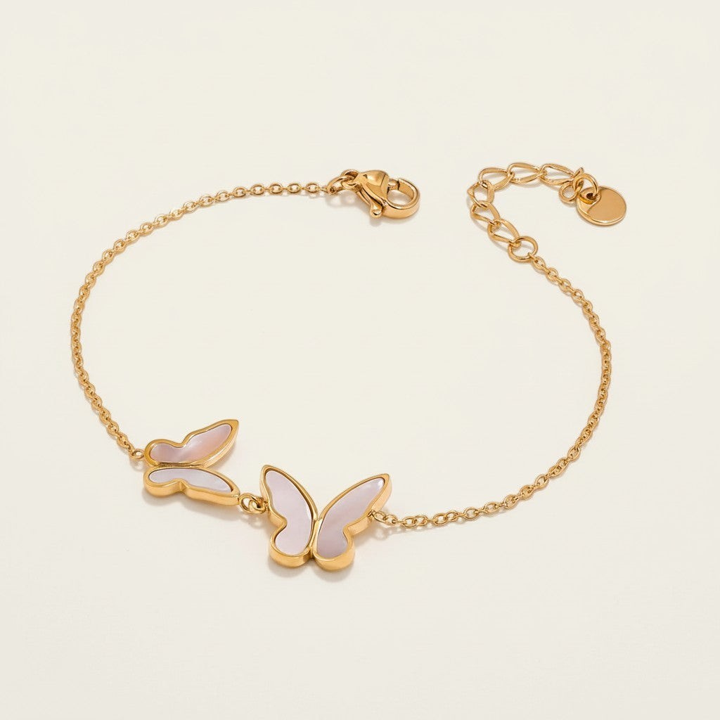 Seraphina Treasures Metis gold-tone bracelet with two shell butterfly charms, adjustable chain.