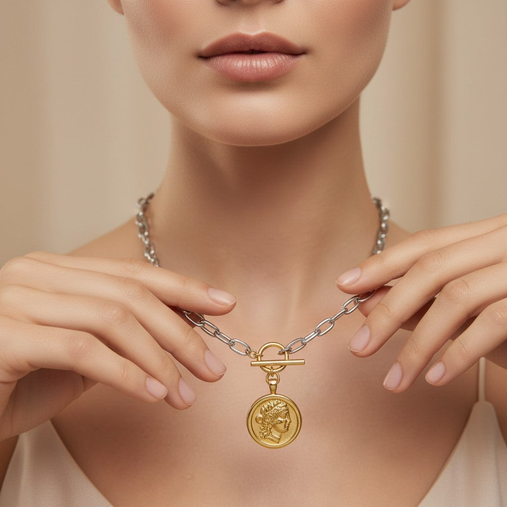 Seraphina Treasures mixed-color double-sided portrait coin necklace with toggle clasp. Gold pendant on silver chain.