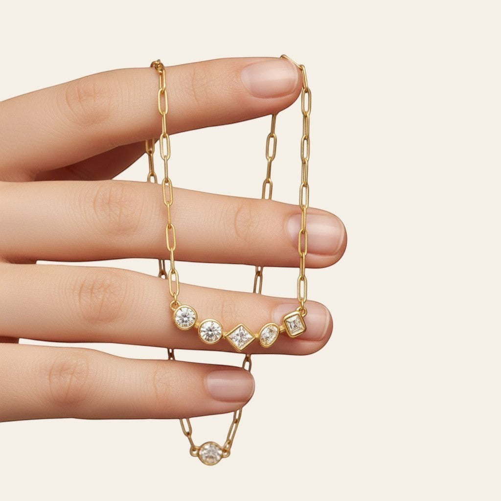 Seraphina Treasures gold-tone necklace with five clear gemstones in mixed cuts: round, square, and rectangular.