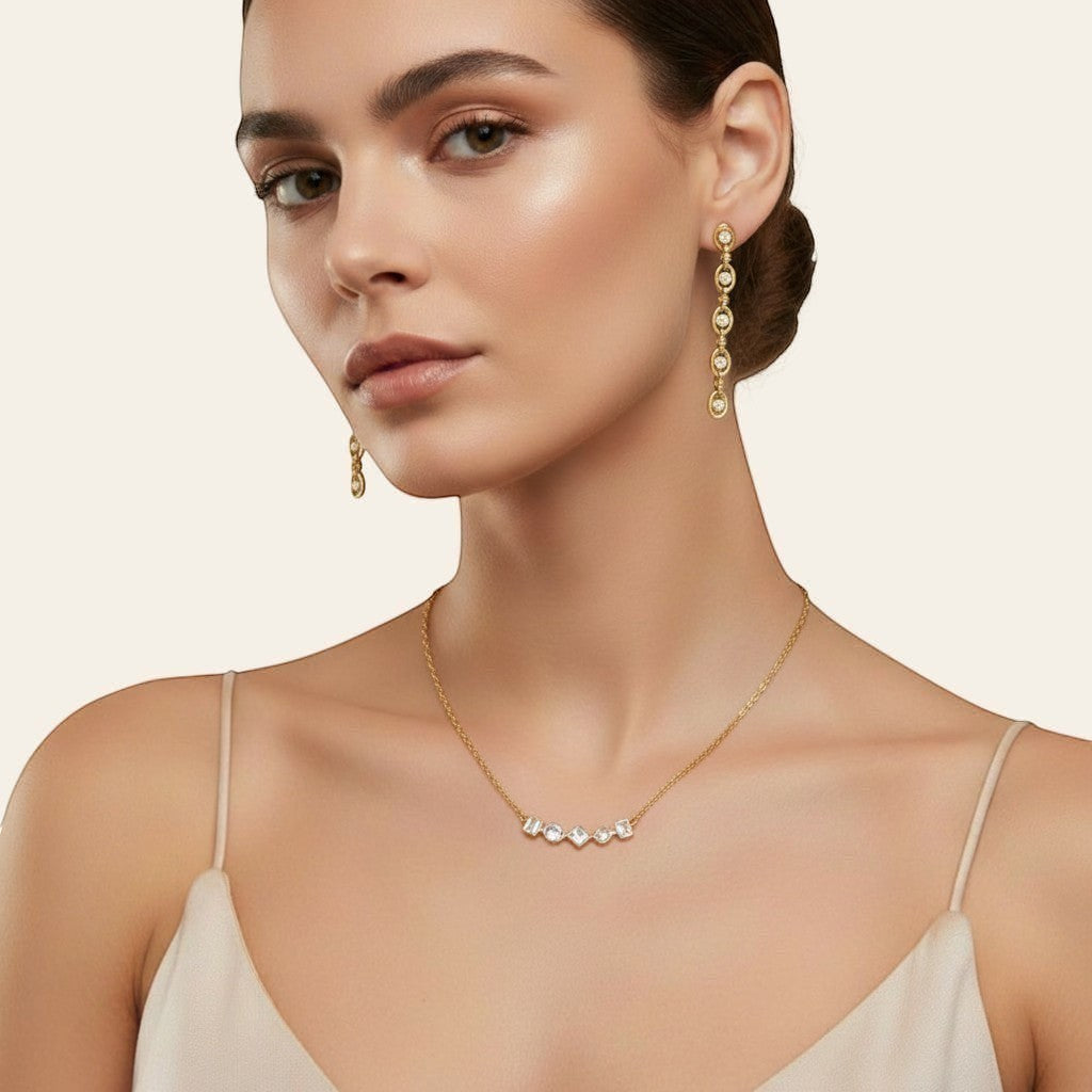 Seraphina Treasures gold-tone necklace with five clear mixed-shape gemstones: round, square, and rectangular.