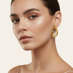 Seraphina Treasures Morviane gold teardrop earrings with spiral design and clear cubic zirconia accent.
