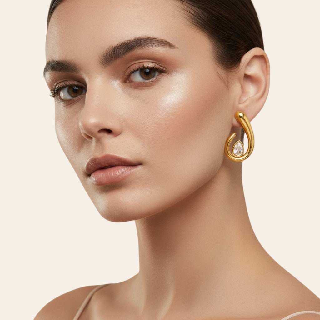 Seraphina Treasures Morviane gold teardrop earrings with spiral design and clear cubic zirconia accent.