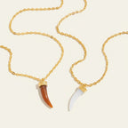 Seraphina Treasures Myrrhena necklace with brown and white horn-shaped resin pendants on gold chains.