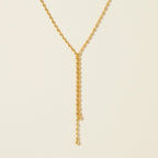 Seraphina Treasures Naomi gold necklace with delicate bead fringes and a drop chain with a small ball accent.
