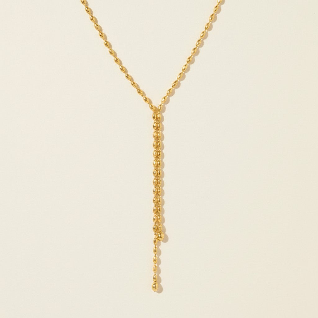Seraphina Treasures Naomi gold necklace with delicate bead fringes and a drop chain with a small ball accent.
