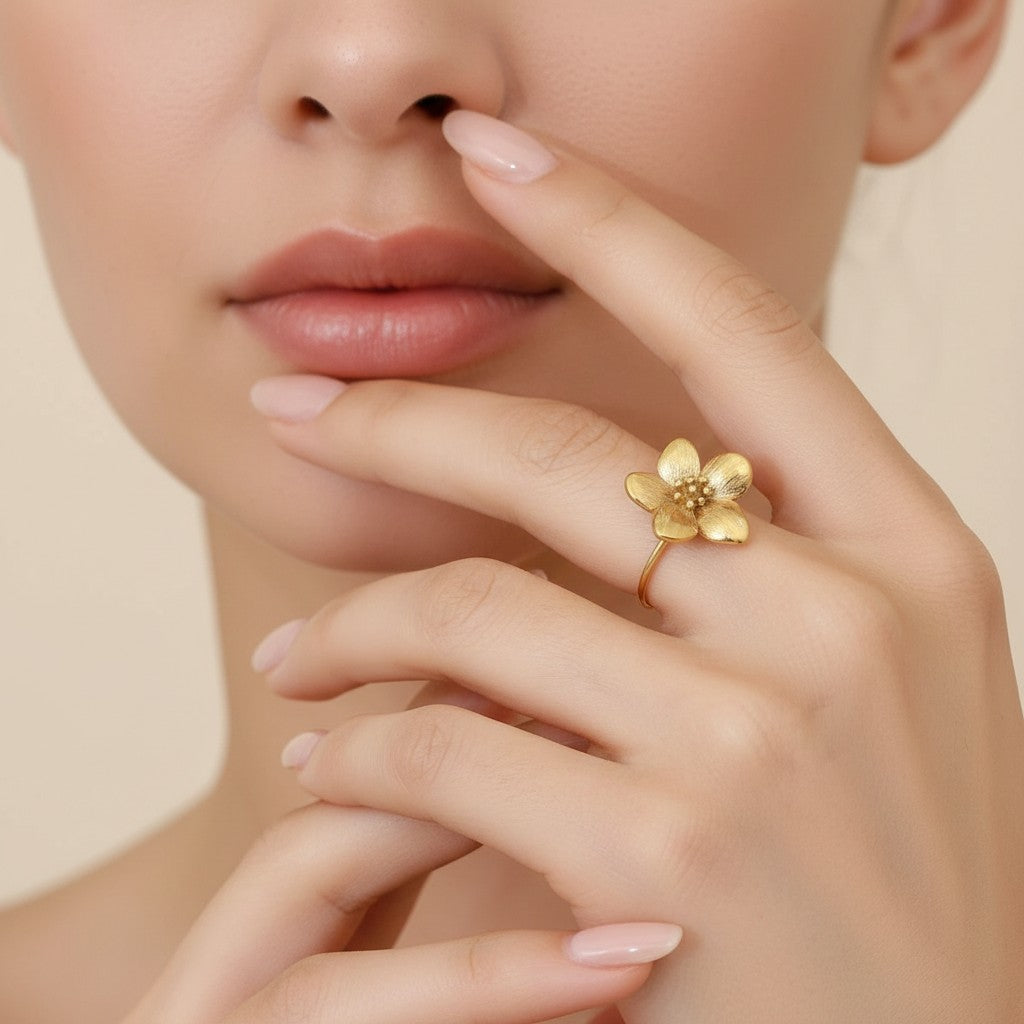 Seraphina Treasures Nerium Ring, a gold-tone open band ring with a detailed floral motif. Delicate and elegant.