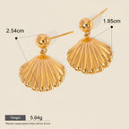 Seraphina Treasures Nerivelle gold shell dangle earrings. Lightweight, hypoallergenic, and waterproof.