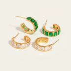 Seraphina Treasures Nyxoria gold hoop earrings with green and white cubic zirconia stones, iced-out design.