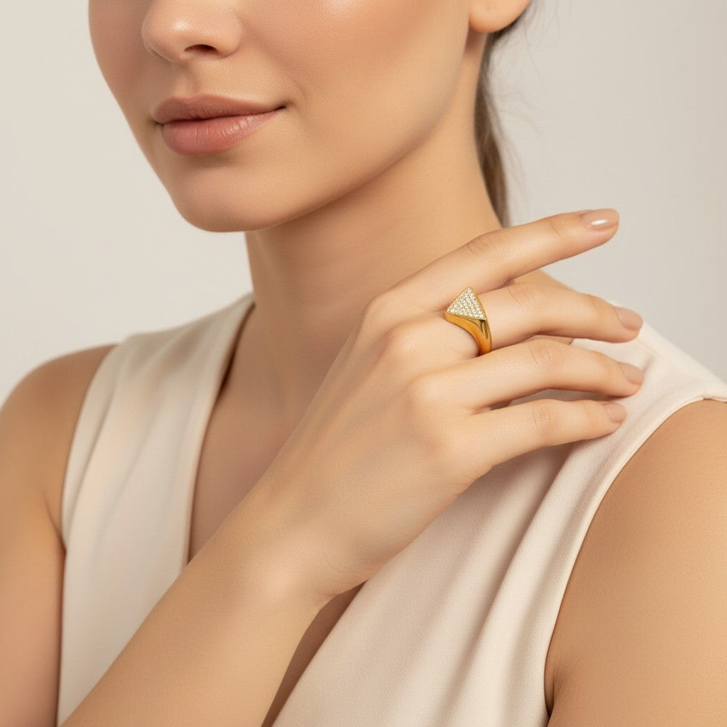 Seraphina Treasures Olyra ring in gold and silver, featuring a triangular design encrusted with rhinestones.
