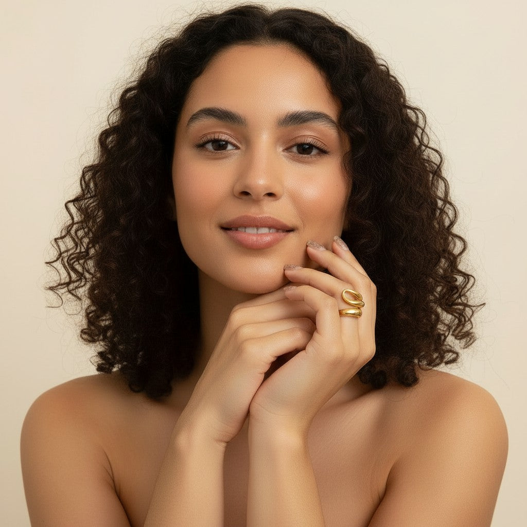 Seraphina Treasures Ondara gold ring with hollow, smooth, curved design on a model's finger.