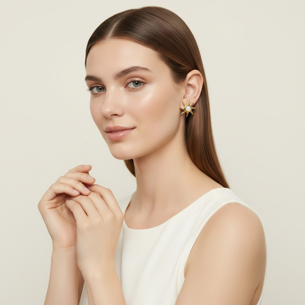 Seraphina Treasures Ophelia gold sunburst earrings with opal center, featuring a radiant sun motif.