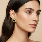 Seraphina Treasures Ophira gold square earrings with black inlay and textured design. Model wears earrings with other ear piercings.