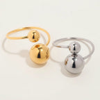 Seraphina Treasures Orbis ring in gold and silver, featuring contrasting ball sizes in a geometric design.