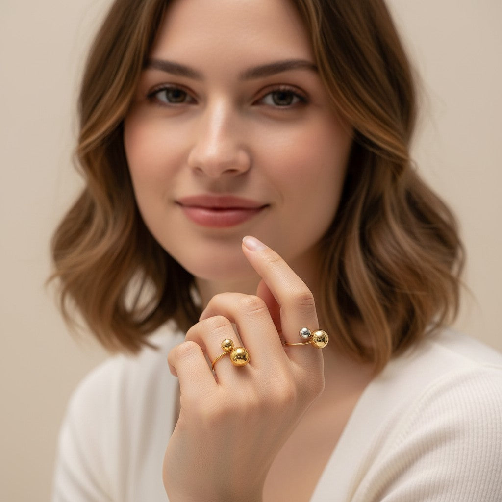 Seraphina Treasures Orbis ring with contrasting gold and silver spheres on a geometric band.