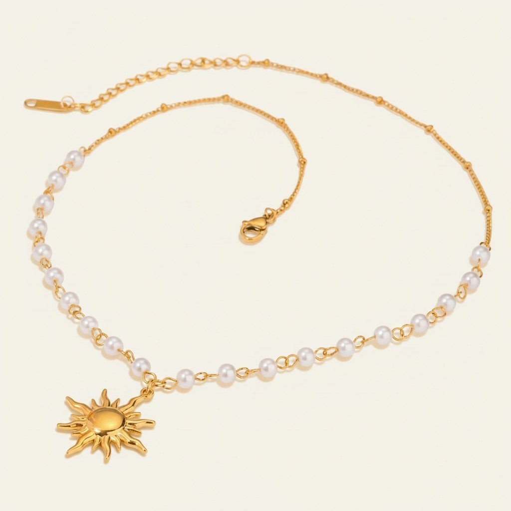 Seraphina Treasures Oria gold necklace with pearl accents and a sun pendant. Elegant chain with small white pearls.