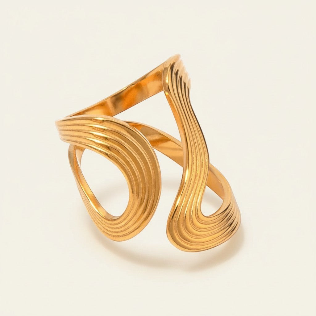 Seraphina Treasures Orichal gold ring with a textured, wavy design. Open cuff style.