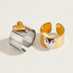 Seraphina Treasures Orvara ring with a gold heart on a silver band and a silver heart on a gold band.