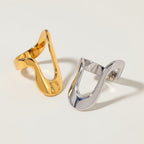 Seraphina Treasures Orvian ring in gold and silver finishes, featuring a modern, open, wavy design.