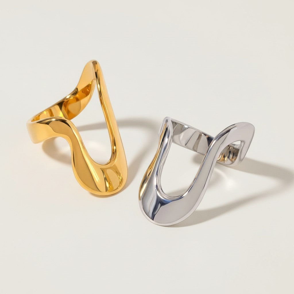 Seraphina Treasures Orvian ring in gold and silver finishes, featuring a modern, open, wavy design.