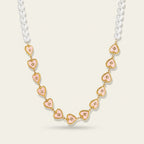 Seraphina Treasures Korvella necklace with imitation pearls and pink heart pendants with gold trim and small clear stones.