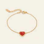 Seraphina Treasures Alara bracelet with a red agate heart charm on a gold chain. Symbolizes love and resilience.