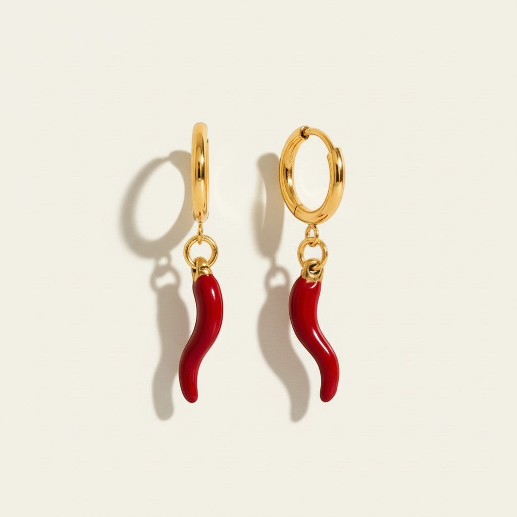 Seraphina Treasures gold hoop earrings with dangling red chili pepper charms. Playful and bold design.