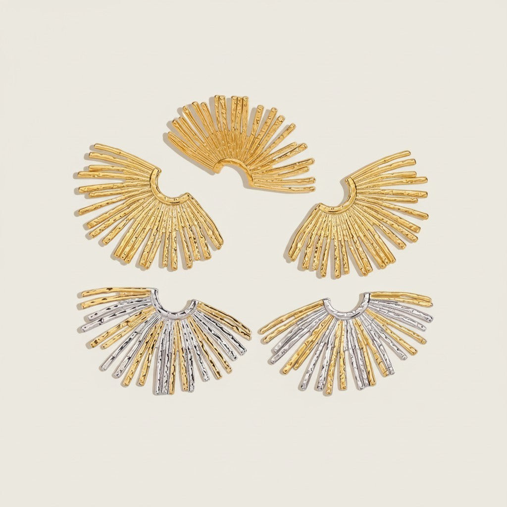 Seraphina Treasures Regalia earrings: gold and silver fan-shaped studs with openwork scalloped pattern and textured rays.