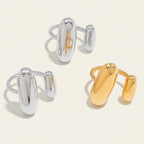 Seraphina Treasures Regara adjustable ring with glossy silver and gold abstract shapes. Modern, elegant jewelry.