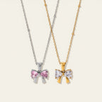 Seraphina Treasures Renenet necklace with bow pendant in silver with pink stones and gold with white stones.