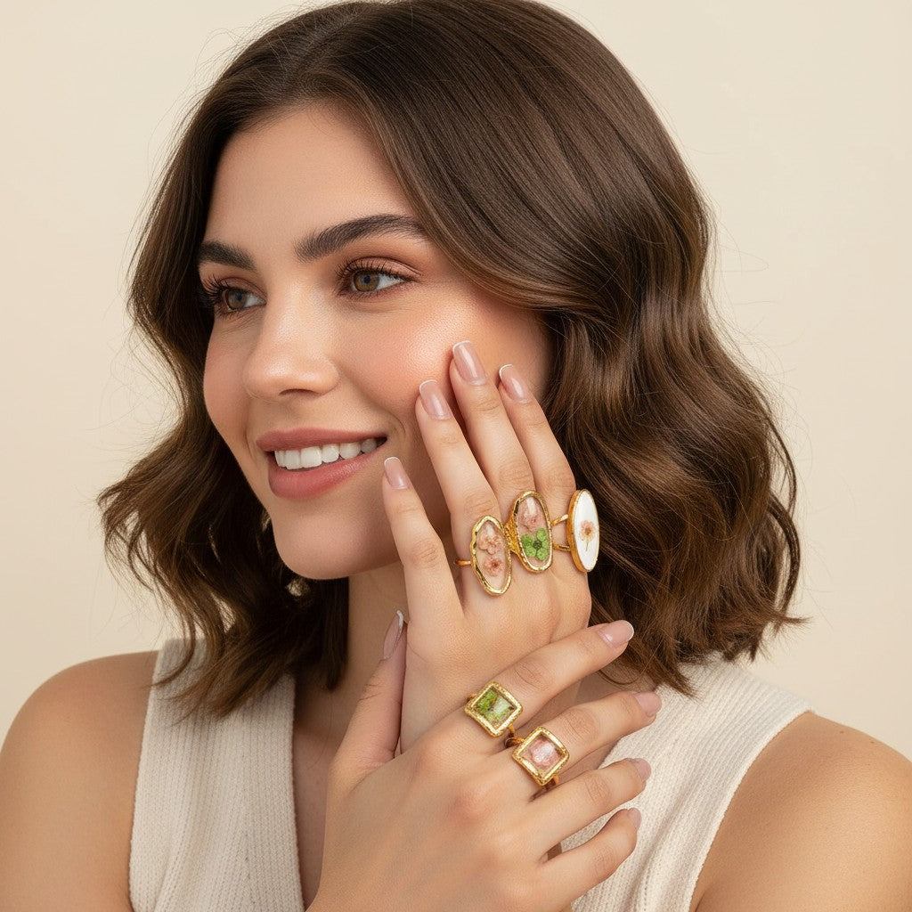 Seraphina Treasures Rosalune rings with pressed flowers in gold settings. Oval, heart, and square shapes.