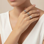 Seraphina Treasures Sapphira ring with a heart design in silver and gold tones, worn on a model's hand.
