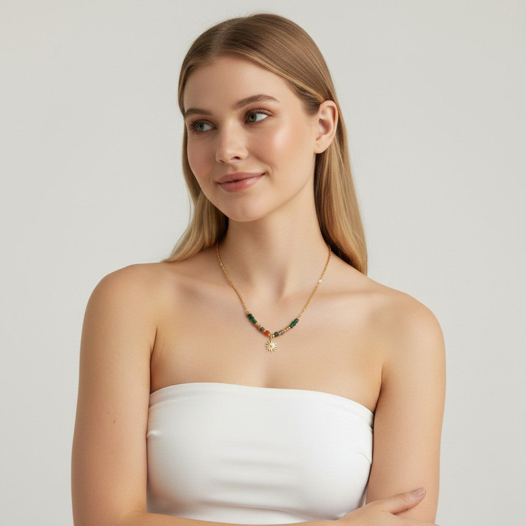 Seraphina Treasures Sarai necklace with a sun pendant and a chain of natural stones in green and orange hues.