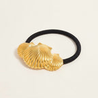 Seraphina Treasures Ishtar gold seashell ribbed hair tie. Black elastic band with decorative gold seashell charm.
