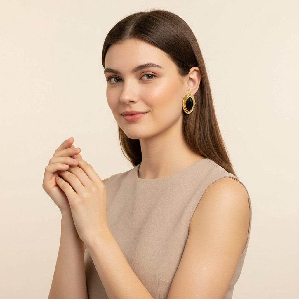 Seraphina Treasures Selenya gold-tone oval earrings with black onyx inlay and equestrian horse eye motif.