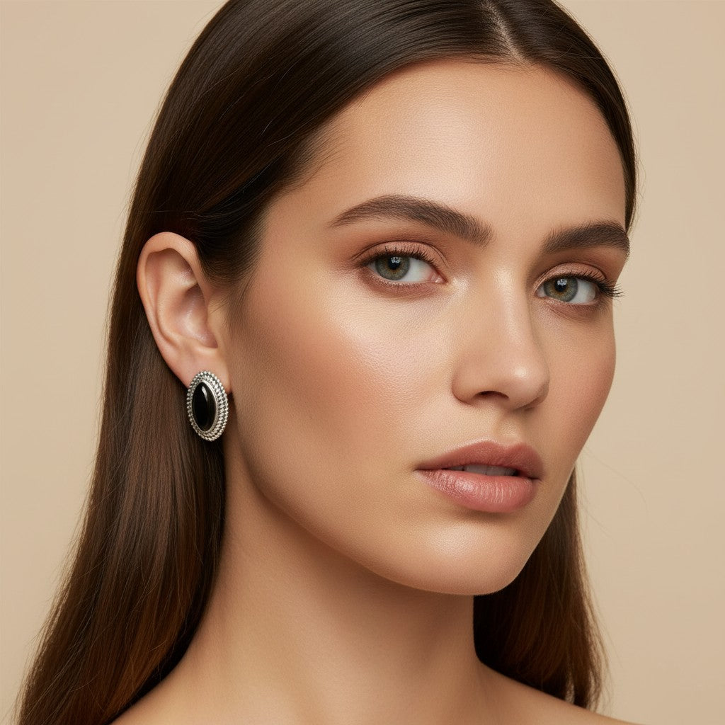Seraphina Treasures Selenya oval black onyx earrings with detailed silver trim, worn by a model.
