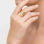 Seraphina Treasures Serastal gold ring with geometric threading and adjustable open band on a hand.