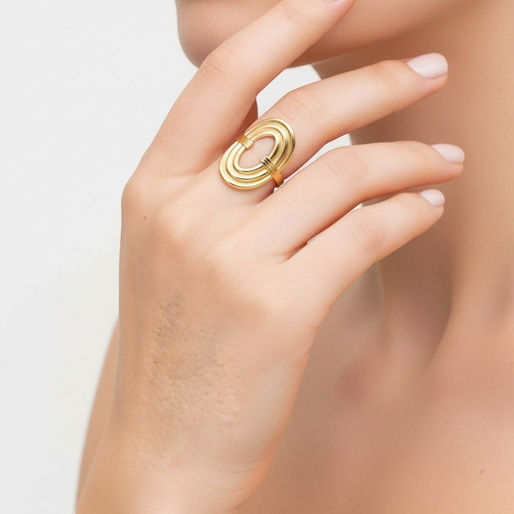Seraphina Treasures Serastal gold ring with geometric threading and adjustable open band on a hand.