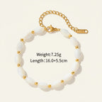 Seraphina Treasures Delia bracelet with oval white shell beads and gold accents, adjustable gold chain.