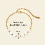 Seraphina Treasures Delia bracelet with white shell beads and gold accents on a gold chain.