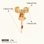 Seraphina Treasures gold-tone ring with shell and coral charms, pearl accent, and red bead chain. Adjustable cuff style.