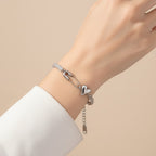 Seraphina Treasures silver bracelet with chain, safety pin, heart charm, and cubic zirconia stones.