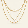 Seraphina Treasures Skotera gold layered necklace with zircon pendant. Features figaro, box, and bead chains.