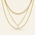 Seraphina Treasures Skotera gold layered necklace with zircon pendant. Features figaro, box, and bead chains.