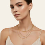 Seraphina Treasures Skotera gold three-layer necklace with a round zircon pendant and curb and ball chains.