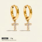 Seraphina Treasures Solara gold hoop earrings with cubic zirconia cross charms. Waterproof and hypoallergenic.