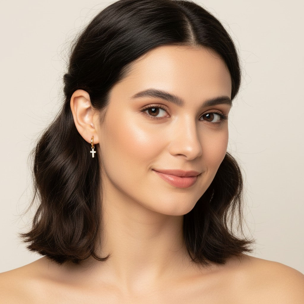 Seraphina Treasures Solara gold hoop earrings with cubic zirconia cross and star charms.