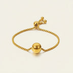 Seraphina Treasures Solis gold-tone adjustable bracelet with a smooth ball pendant and bead accents.