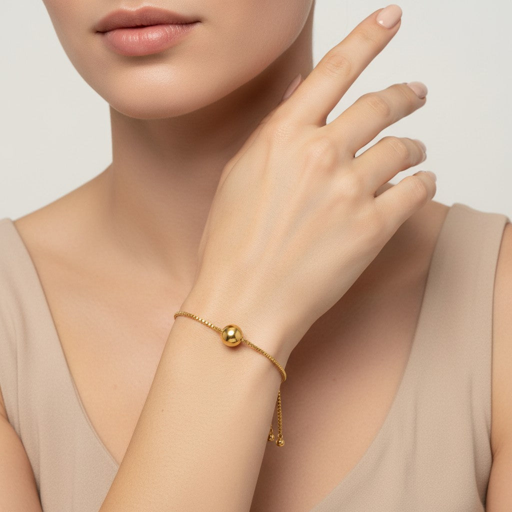 Seraphina Treasures Solis gold-tone adjustable bracelet with a polished ball pendant and box chain.