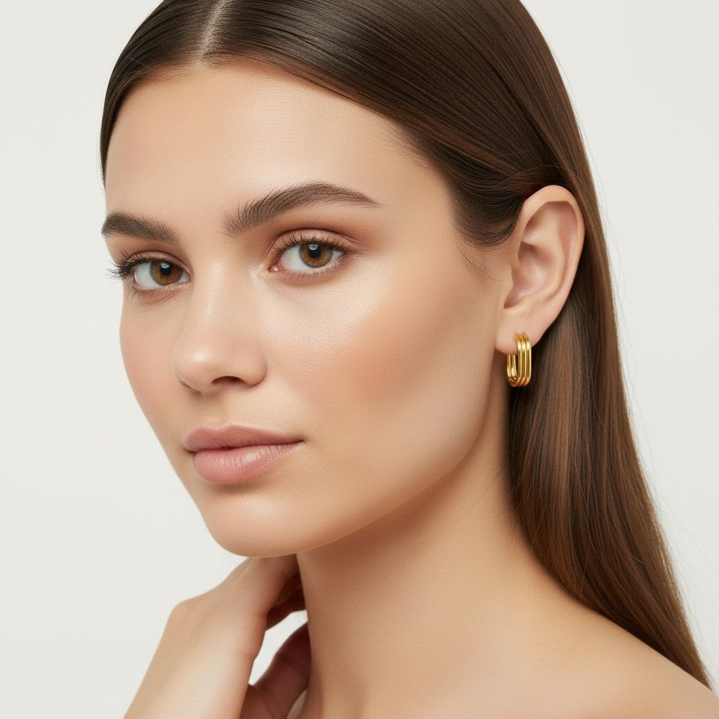 Seraphina Treasures Solisia gold layered oval hoop earrings on model.